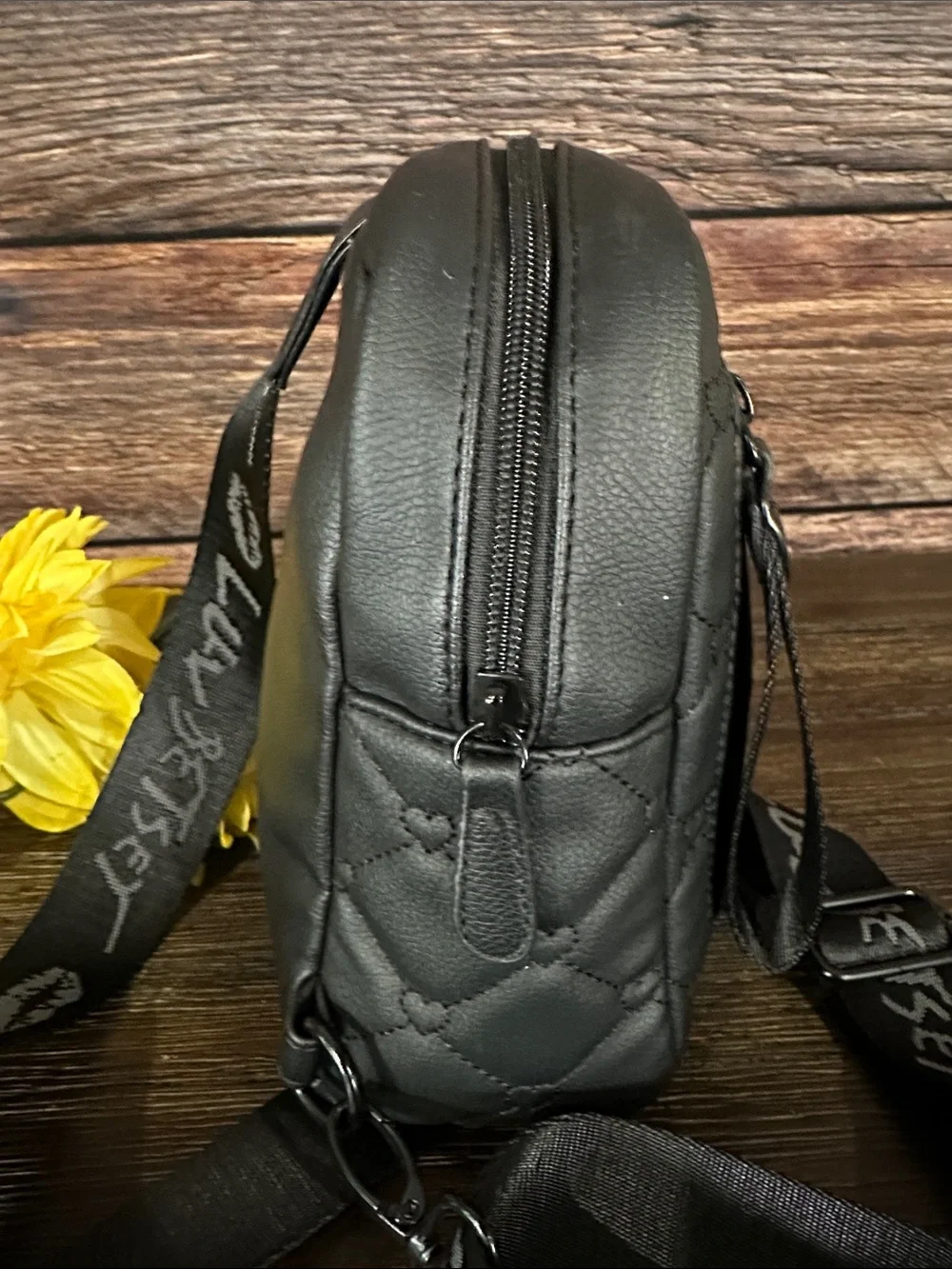 Luv Betsey by Betsey Johnson black quilted heart sling backpack.